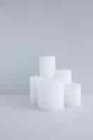 Free photo close-up of white candles against grey background