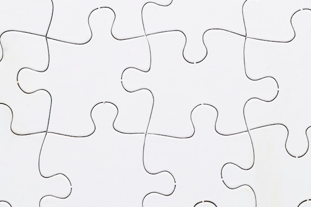 Close-up of white jigsaw puzzle grid background