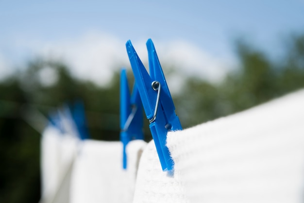 Free Photo close-up white laundry hanging on a string outdoors