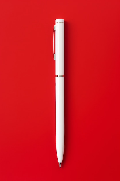 Free photo close up on white pen on red background