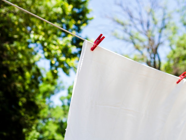 Close-up white sheet drying on the line