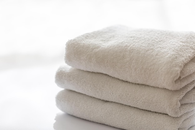 Close up white terry bath towels stacked spa concept