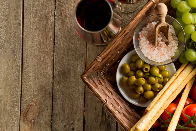 Close-up of wine glasses next to a wicker basket with products