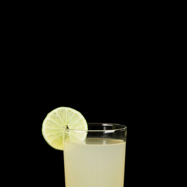 Free photo close-up with glass of lemonade in the dark