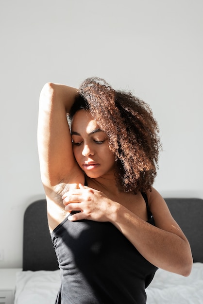 Close up on woman applying deodorant