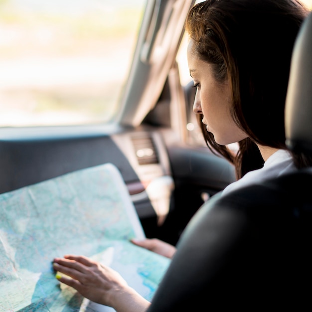 Free photo close-up woman checking map