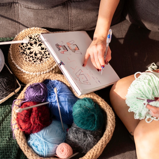 Free photo close-up woman crocheting  according to model