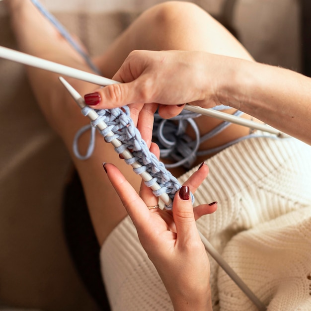 Free photo close-up woman crocheting with blue thread