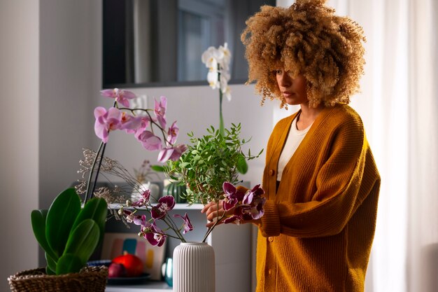 Close up on woman decorating her home with orchids