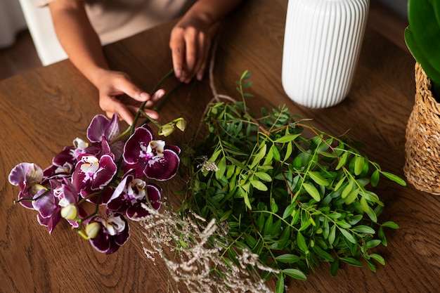 Close up on woman decorating her home with orchids