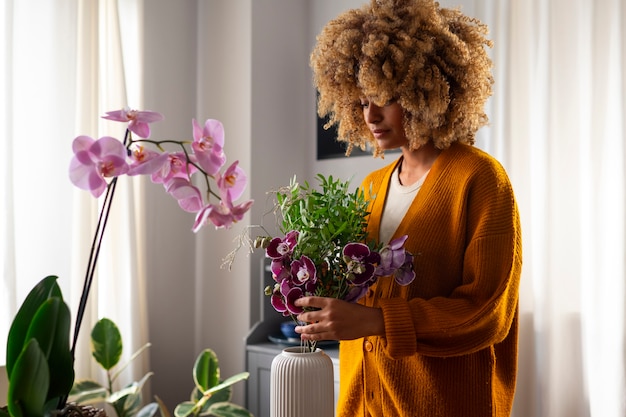 Close up on woman decorating her home with orchids