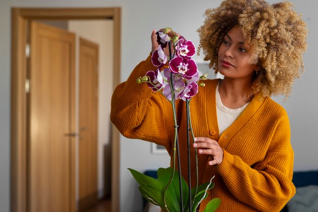 Close up on woman decorating her home with orchids