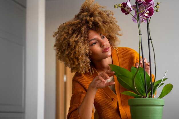 Close up on woman decorating her home with orchids