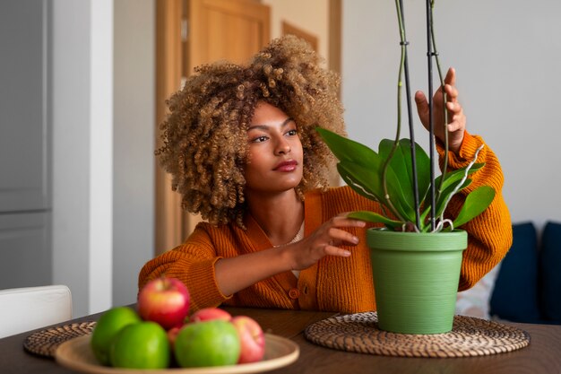 Close up on woman decorating her home with orchids