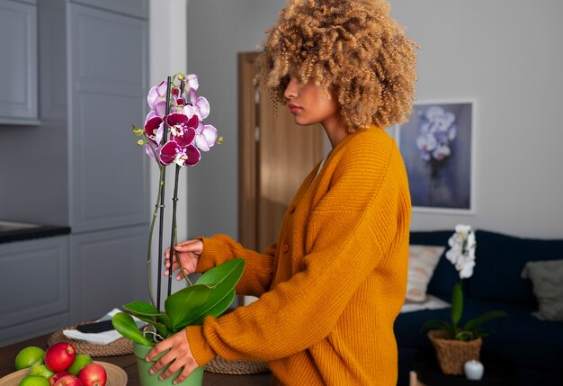 Close up on woman decorating her home with orchids