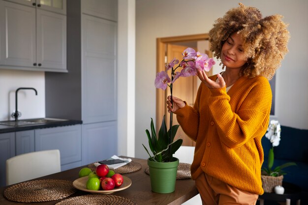 Close up on woman decorating her home with orchids