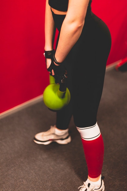 Free photo close-up of a woman doing exercise with kettlebell