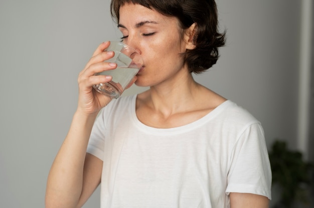 Close up woman drinking water