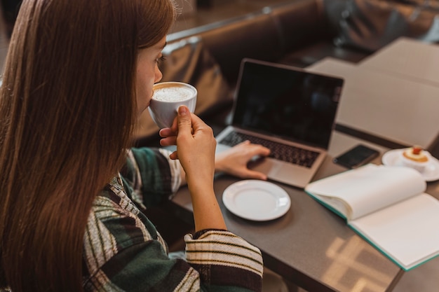 Close up of a woman enjoying a coffee cup