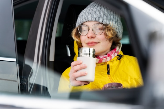 Free photo close up on woman enjoying hot drink while on winter trip