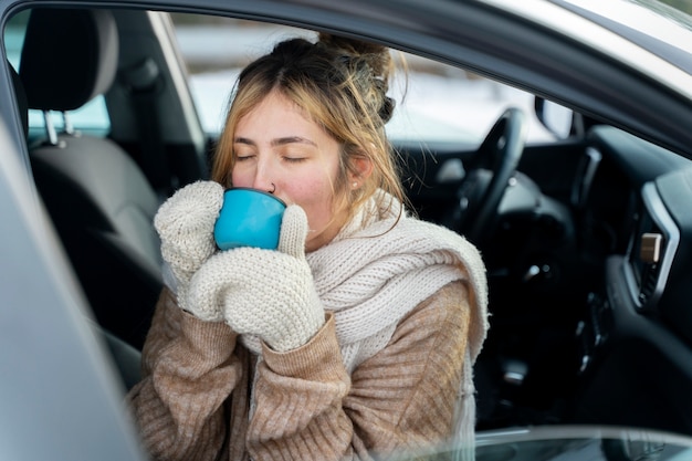 Free photo close up on woman enjoying hot drink while on winter trip