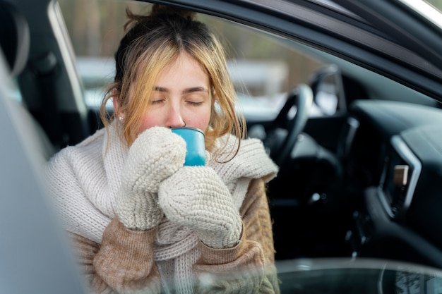 Free photo close up on woman enjoying hot drink while on winter trip