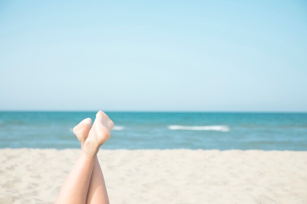 Close up woman feet at the seaside