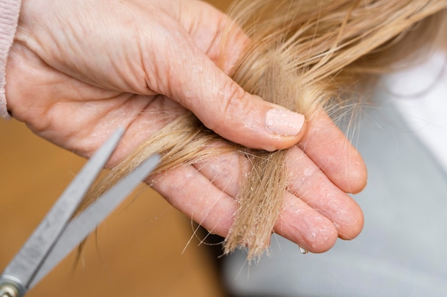 Close-up of woman getting a haircut