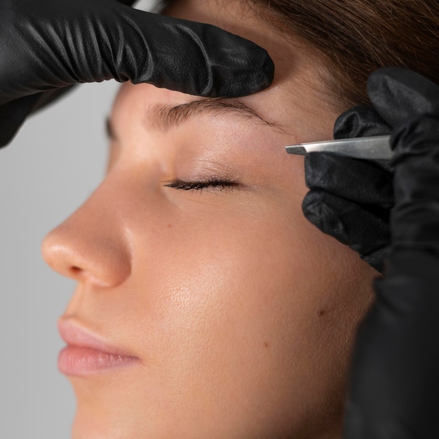 Close-up of woman getting her eyebrows done