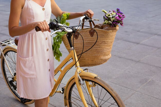 Close up woman holding bicycle