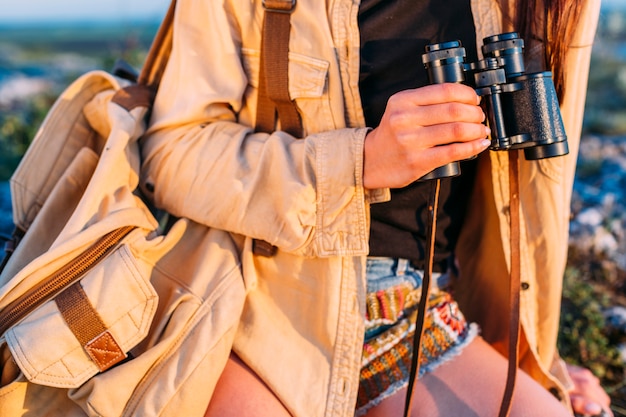 Close-up of a woman holding binocular