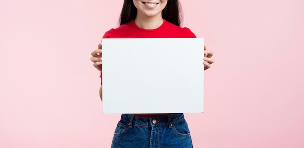 Close-up woman holding blank paper sheet