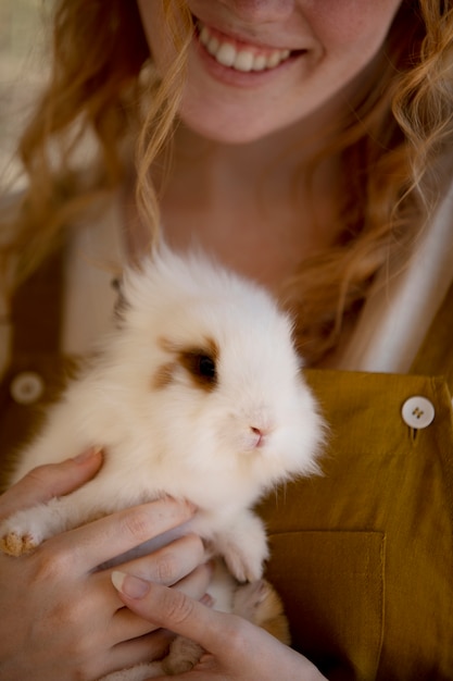 Free Photo close up woman holding bunny