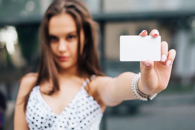 Close-up woman holding a card