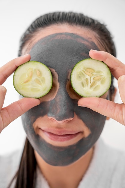 Close-up woman holding cucumber slices