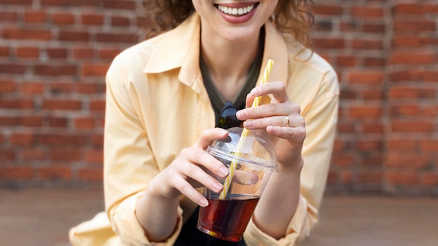 Free photo close up  woman holding cup