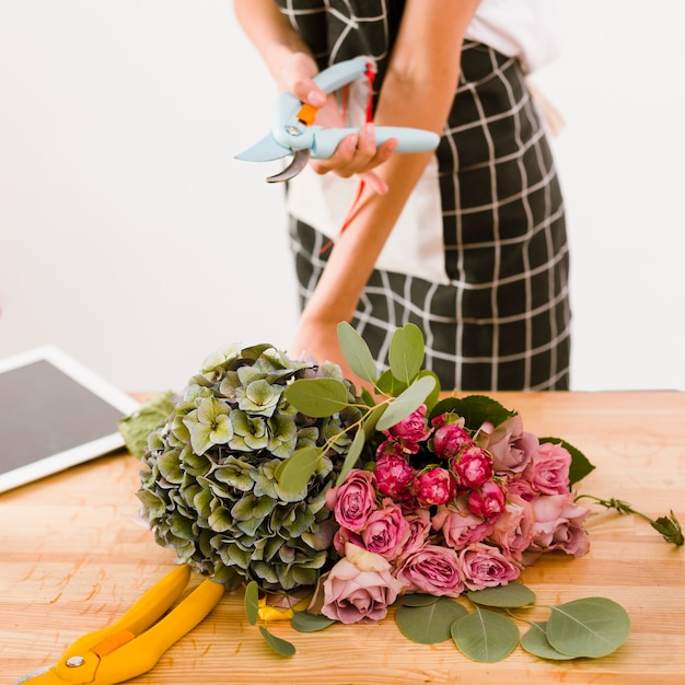 Free Photo close-up woman holding a flower scissors