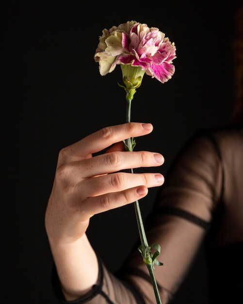 Close-up woman holding a flower