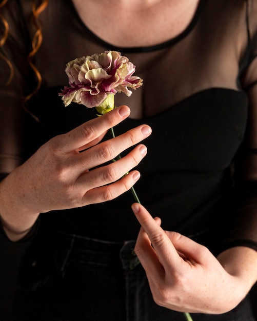 Free photo close-up woman holding a flower