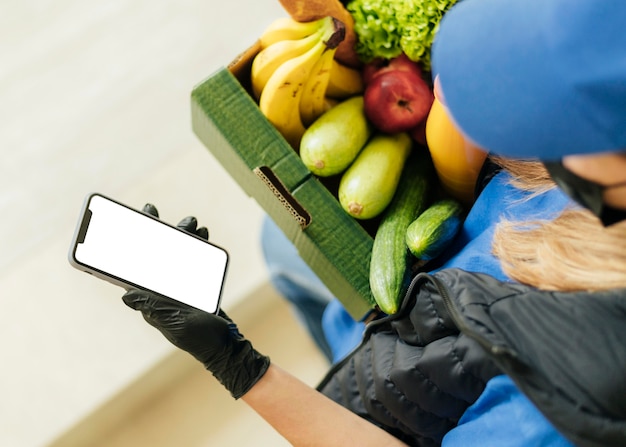 Free Photo close-up woman holding food crate