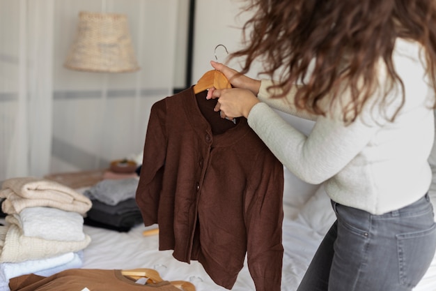 Free Photo close up woman holding hanger