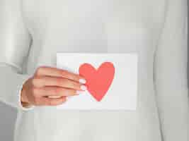 Free photo close up woman holding heart envelope