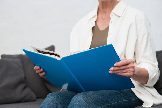 Close-up woman holding magazine