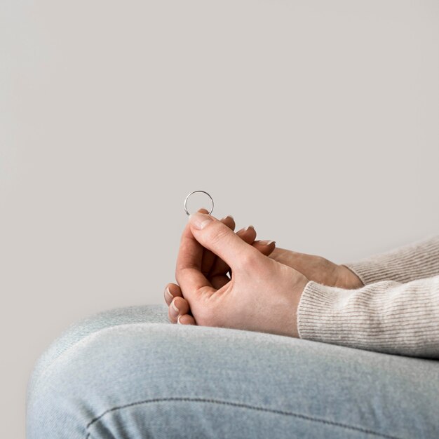 Close-up woman holding marrige ring