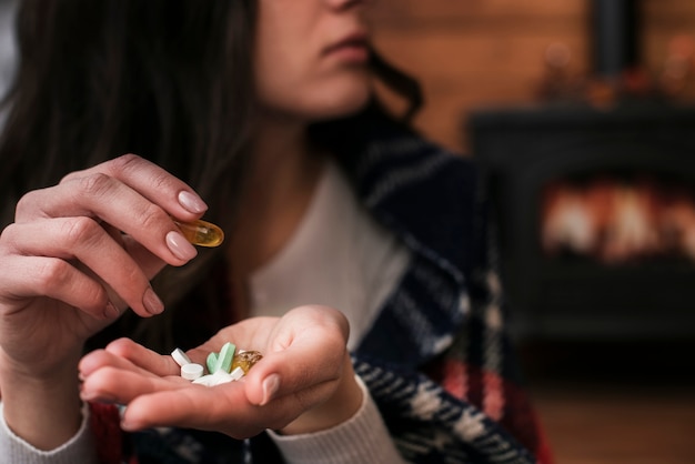 Free Photo close-up woman holding medicine in her hand