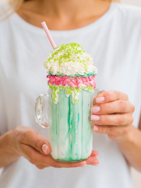 Close-up woman holding milkshake