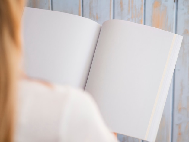 Close-up woman holding a mock-up magazine