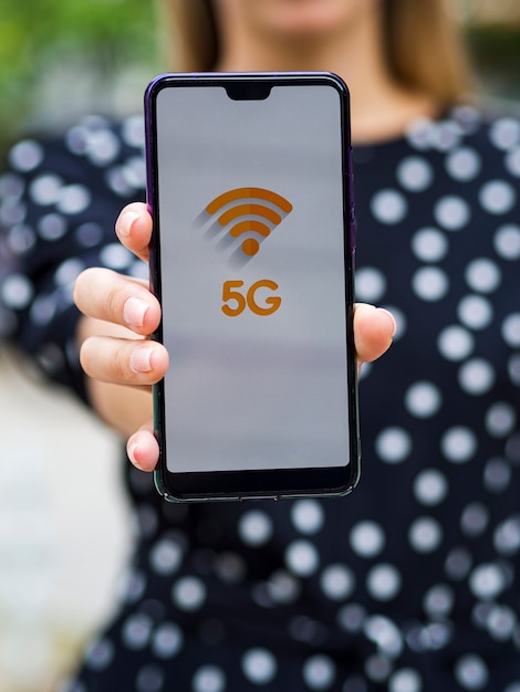 Free photo close-up woman holding phone in front of camera