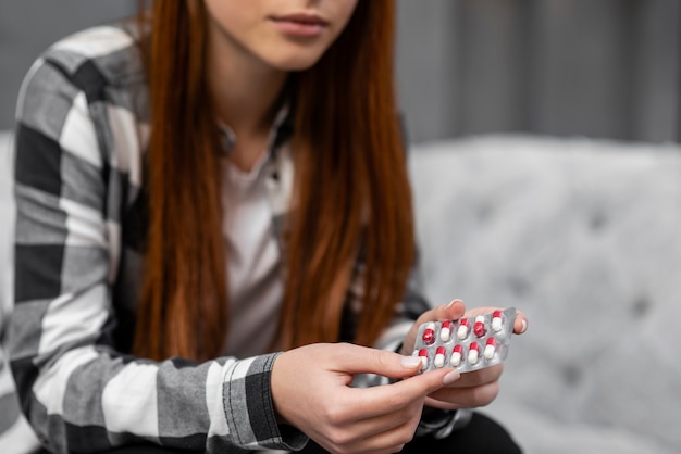 Free Photo close up of woman holding pills