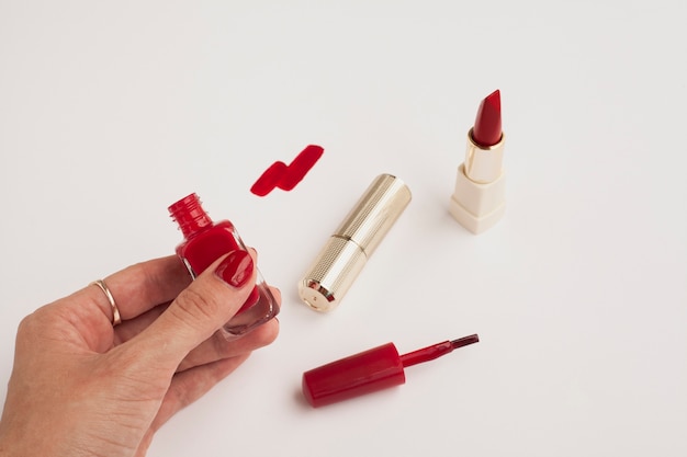 Close-up woman holding red nail polish